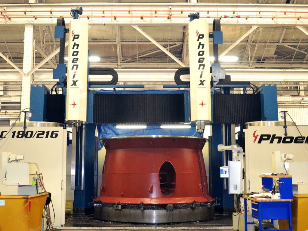 Phoenix CNC vertical turning lathe machining a large red steel component at Brilex