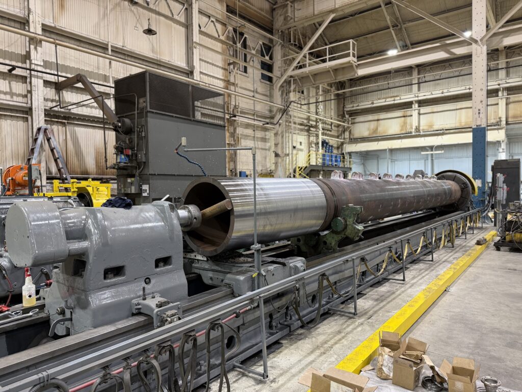 Skoda heavy duty CNC lathe machining a long steel roll in the Brilex machine shop