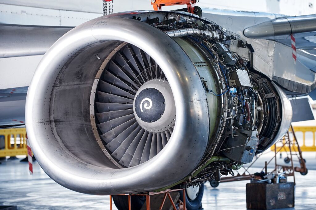 Close-up of a commercial jet engine under maintenance in an aircraft hangar