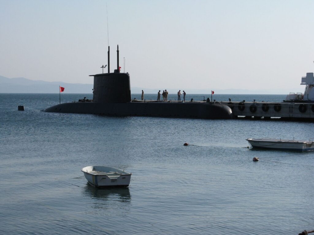 Submarine docked at a pier, representing Brilex manufacturing for NAVSEA and naval programs